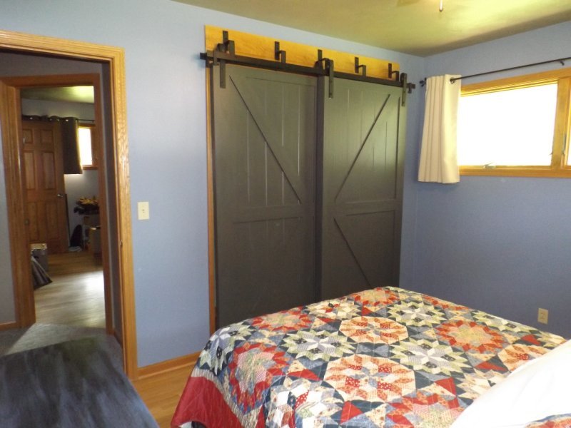 340 Tree Lane Prophetstown, IL 61277 - Photo 17 of 30 a bedroom with a bed and wooden floor