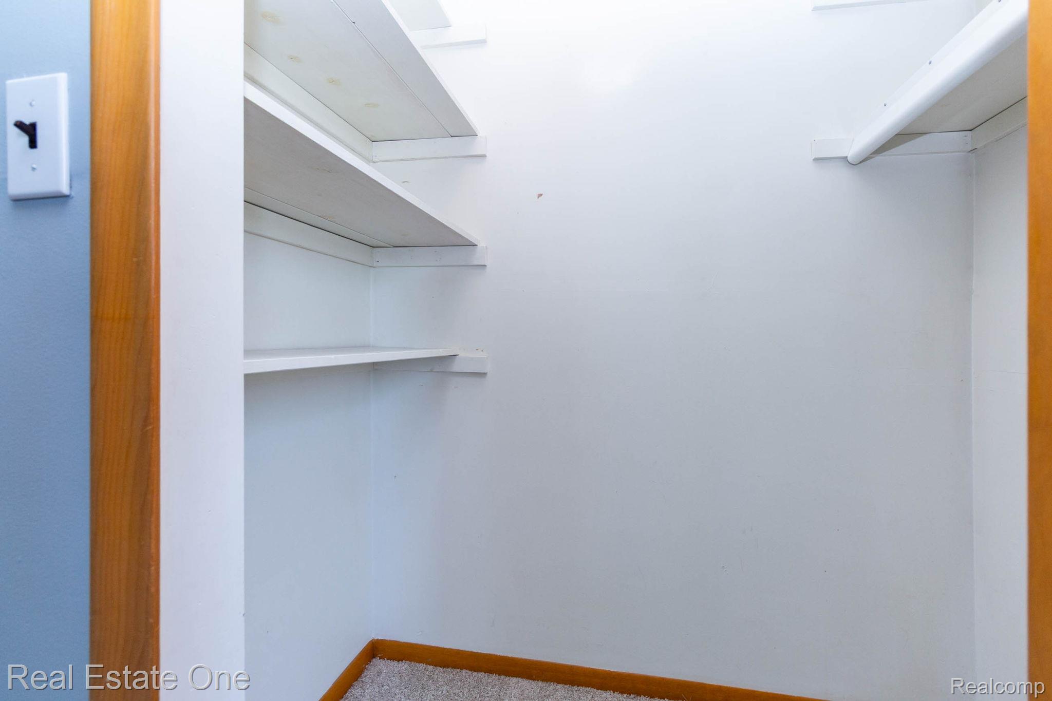 13912 Clinton River Road Sterling Heights, MI 48313 - Photo 21 of 43 Interior storage closet featuring multiple built-in white shelving units