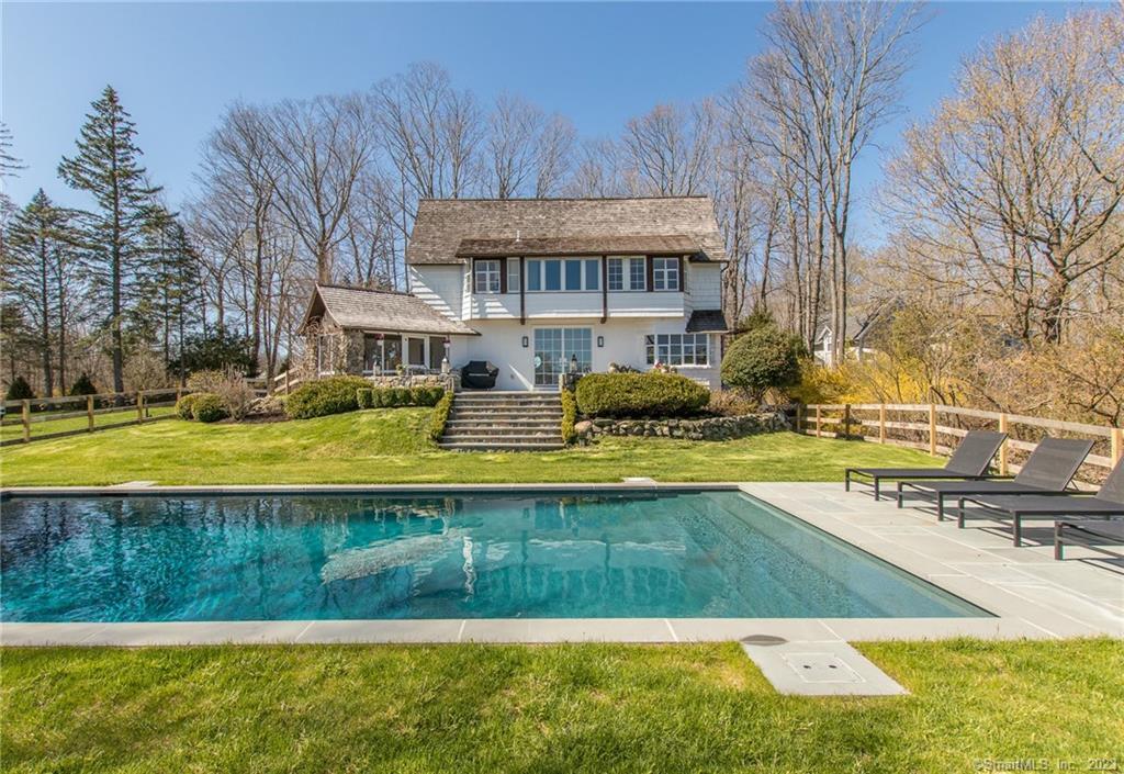 a view of swimming pool with outdoor seating and yard