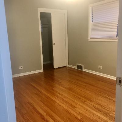 3439 West 84th Street Chicago, IL 60652 - Photo 14 of 32 an empty room with wooden floor and windows