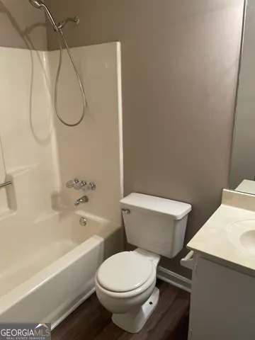 a white toilet sitting next to a bath tub and a shower