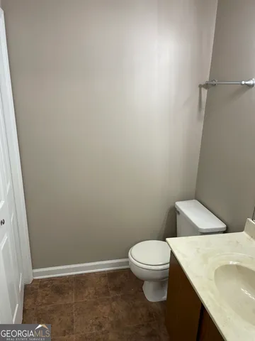 a white toilet sitting next to a white sink