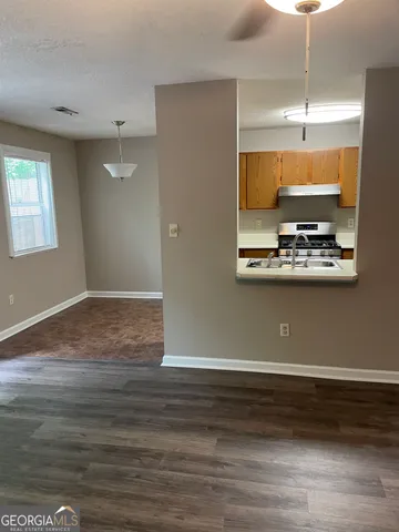 a view of a room with wooden floor