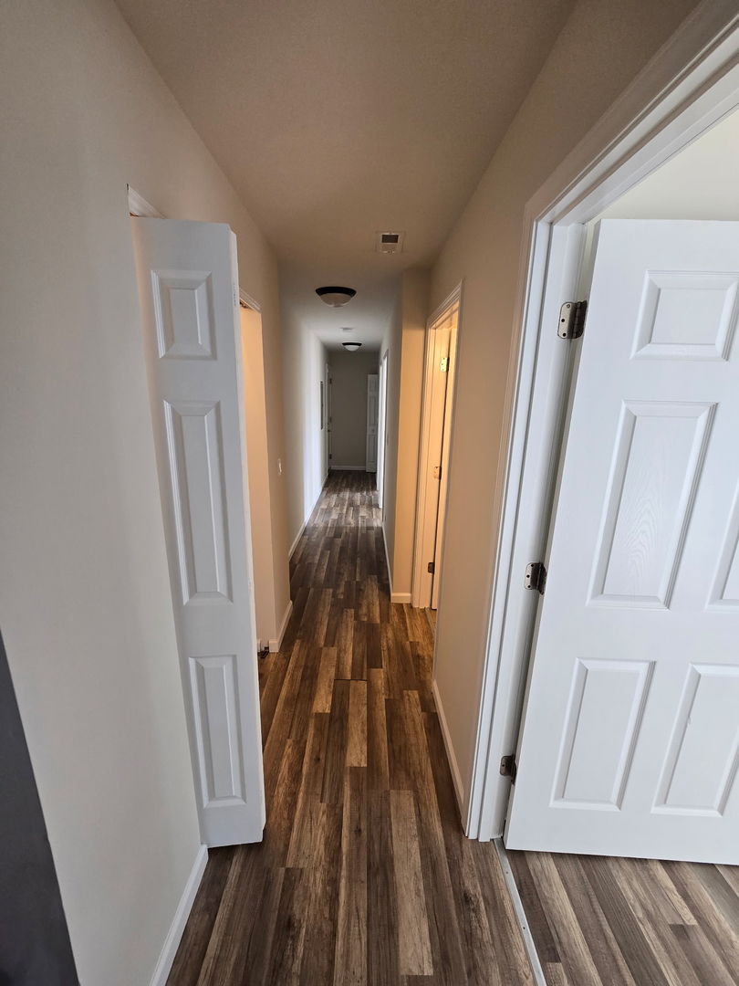 5223 West Washington Boulevard, Unit 52232 Chicago, IL 60644 - Photo 3 of 10 a view of a hallway view with wooden floor and staircase
