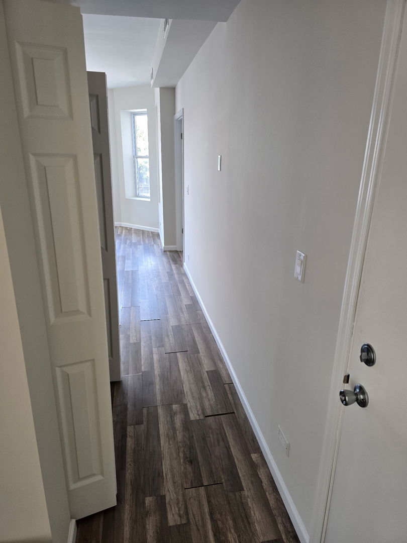 5223 West Washington Boulevard, Unit 52232 Chicago, IL 60644 - Photo 10 of 10 a view of a hallway with wooden floor and staircase