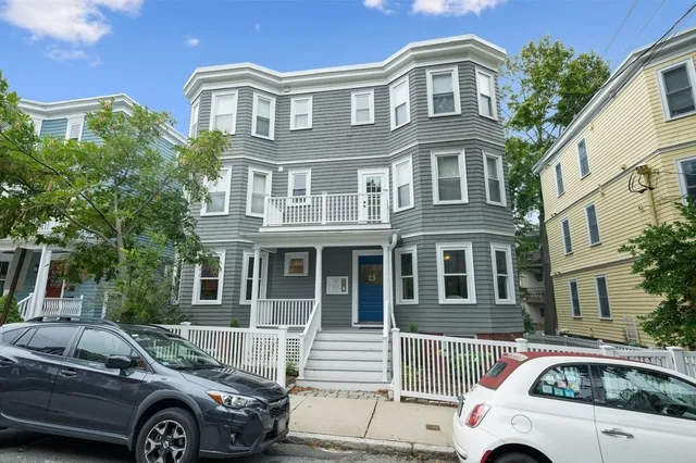 a front view of a house with parking space