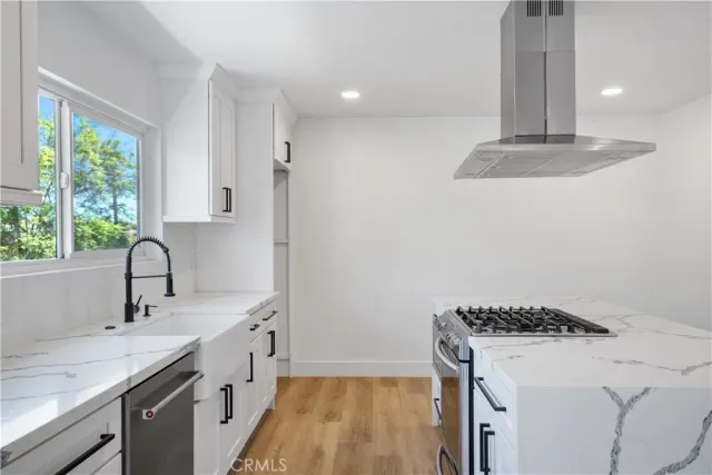 a kitchen with a stove and a sink