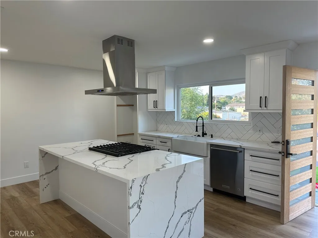632 Truly Vista, Unit 634 Vista, CA 92084 - Photo 14 of 73 a kitchen that has a sink a stove and wooden floor
