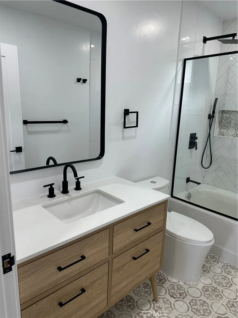 632 Truly Vista, Unit 634 Vista, CA 92084 - Photo 26 of 73 a bathroom with a granite countertop sink toilet mirror and shower