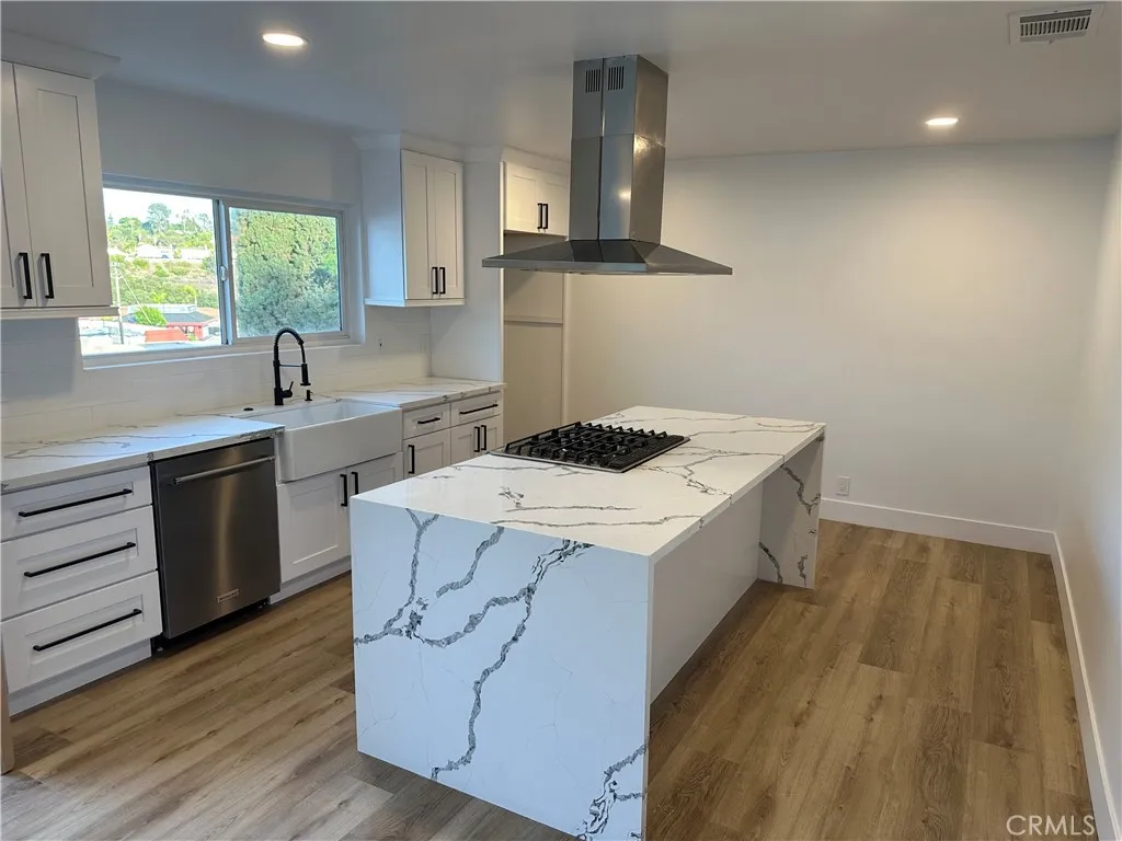 632 Truly Vista, Unit 634 Vista, CA 92084 - Photo 41 of 73 a kitchen with a sink a stove cabinets and wooden floor