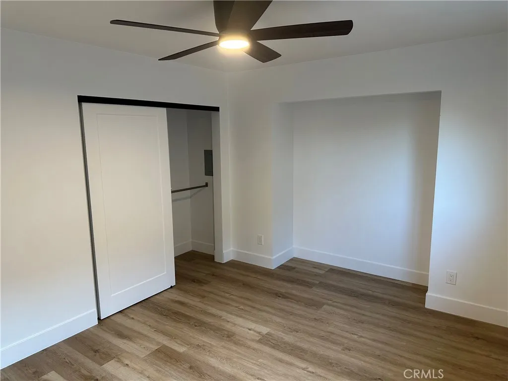 632 Truly Vista, Unit 634 Vista, CA 92084 - Photo 51 of 73 an empty room with wooden floor and a ceiling fan