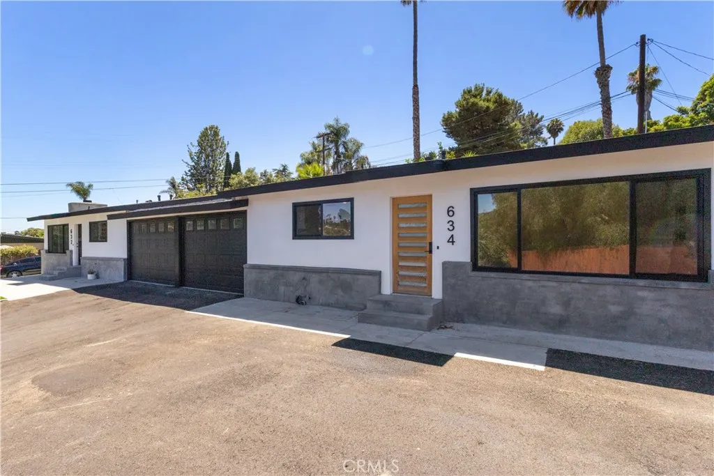 632 Truly Vista, Unit 634 Vista, CA 92084 - Photo 73 of 73 a front view of a house with a yard and garage