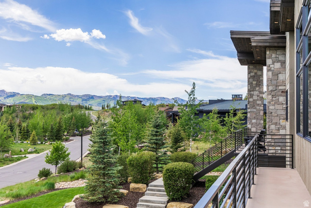 140 West Vista Road Kamas, UT 84036 - Photo 43 of 101 Stone and wood-clad exterior with expansive windows, a concrete balcony, and horizontal metal railings