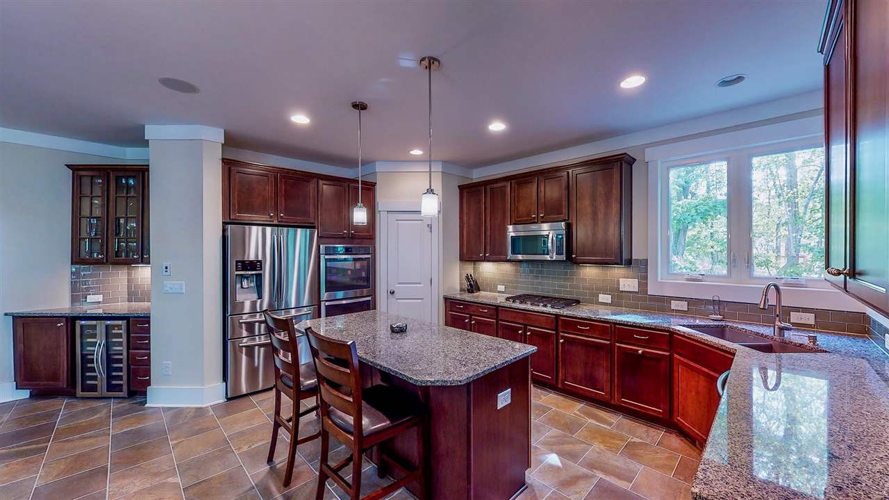 1309 Kintail Drive Raleigh, NC 27613 - Photo 12 of 30 Gourmet kitchen with double ovens, 5 burner gas cooktop, large island, upgraded cabinets and granite. Butler's pantry with wine fridge for your entertainment needs Kitchen
