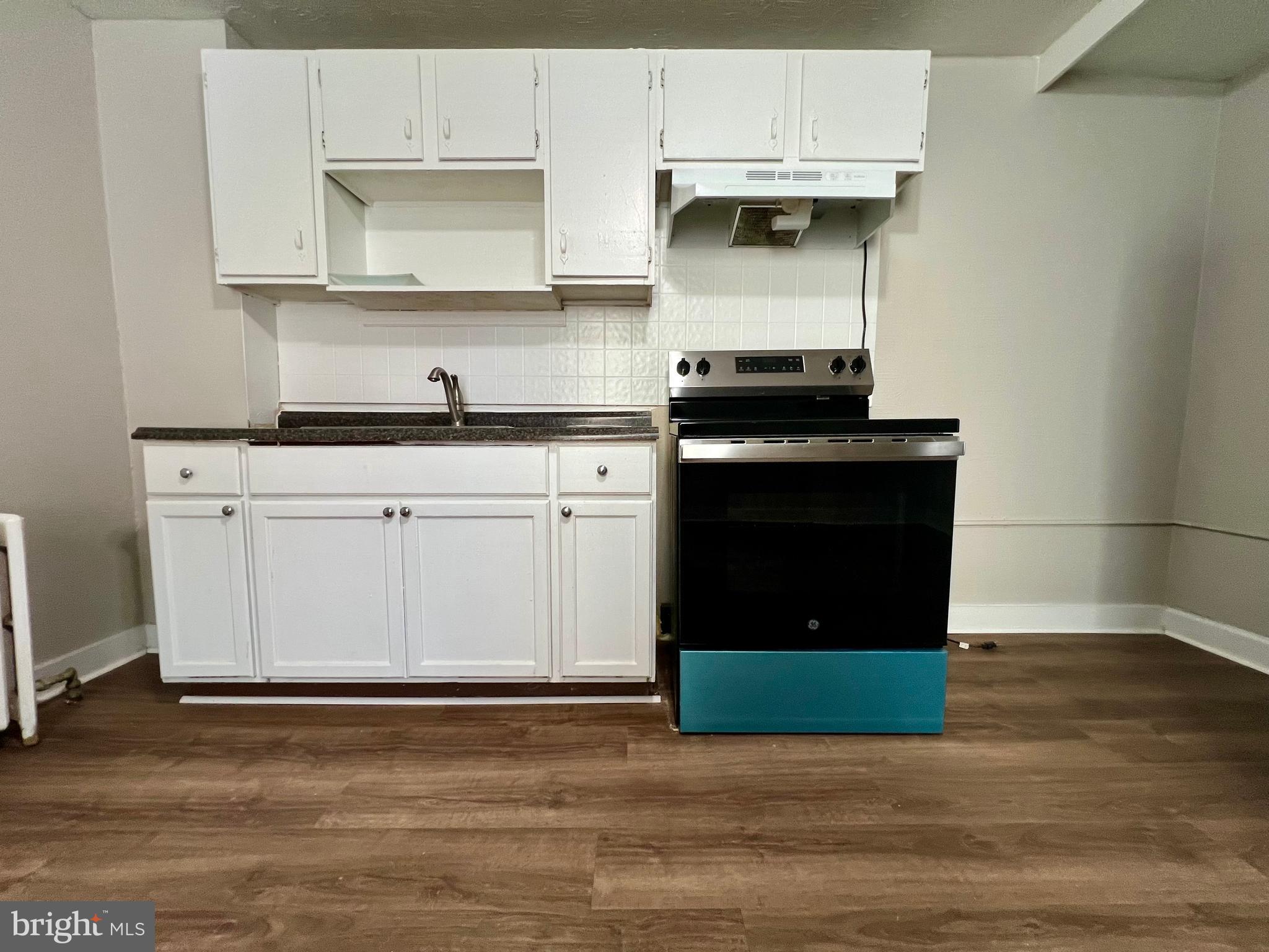 613 Walnut Street Norristown, PA 19401 - Photo 10 of 22 a kitchen with stainless steel appliances granite countertop a stove a sink and a microwave