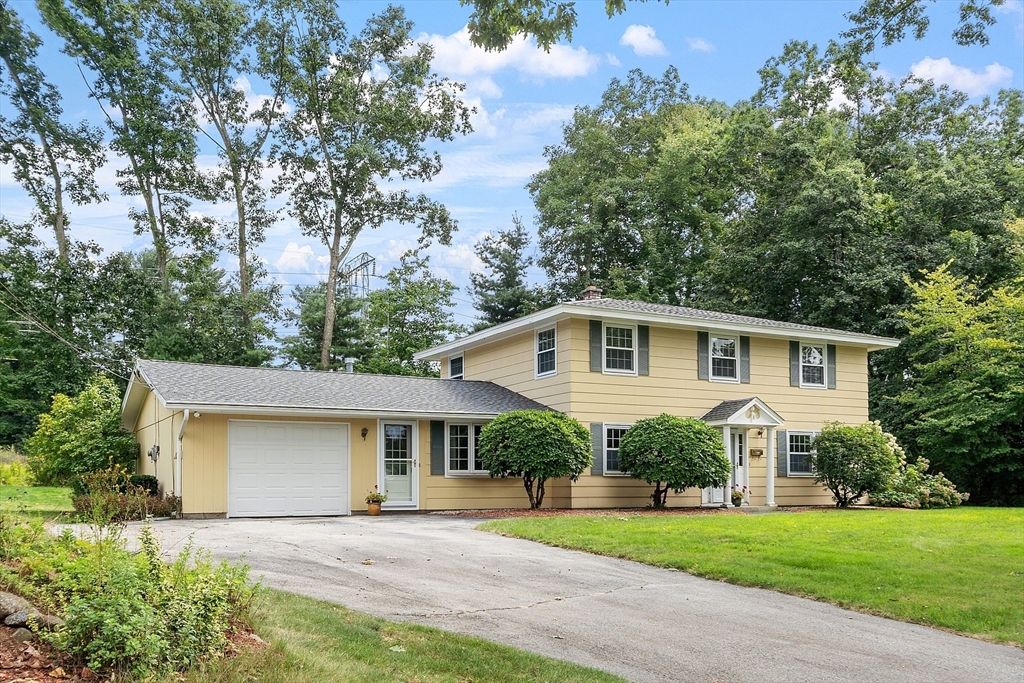 8 Ansie Road Chelmsford, MA 01824 - Photo 1 of 1 a front view of a house with a yard and garage