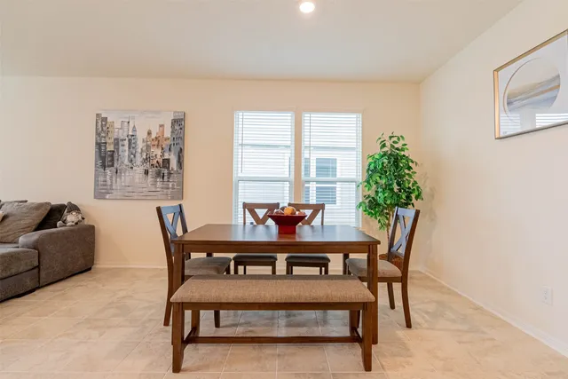 a view of a dining room with furniture and window