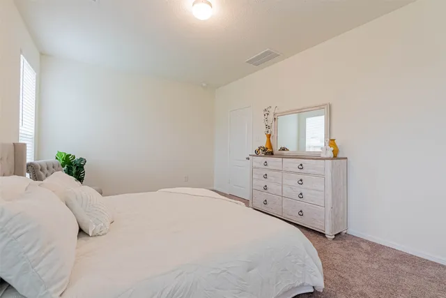 a bathroom with a double vanity sink toilet mirror and shower