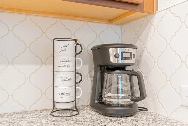 a bedroom with a bed and a chair