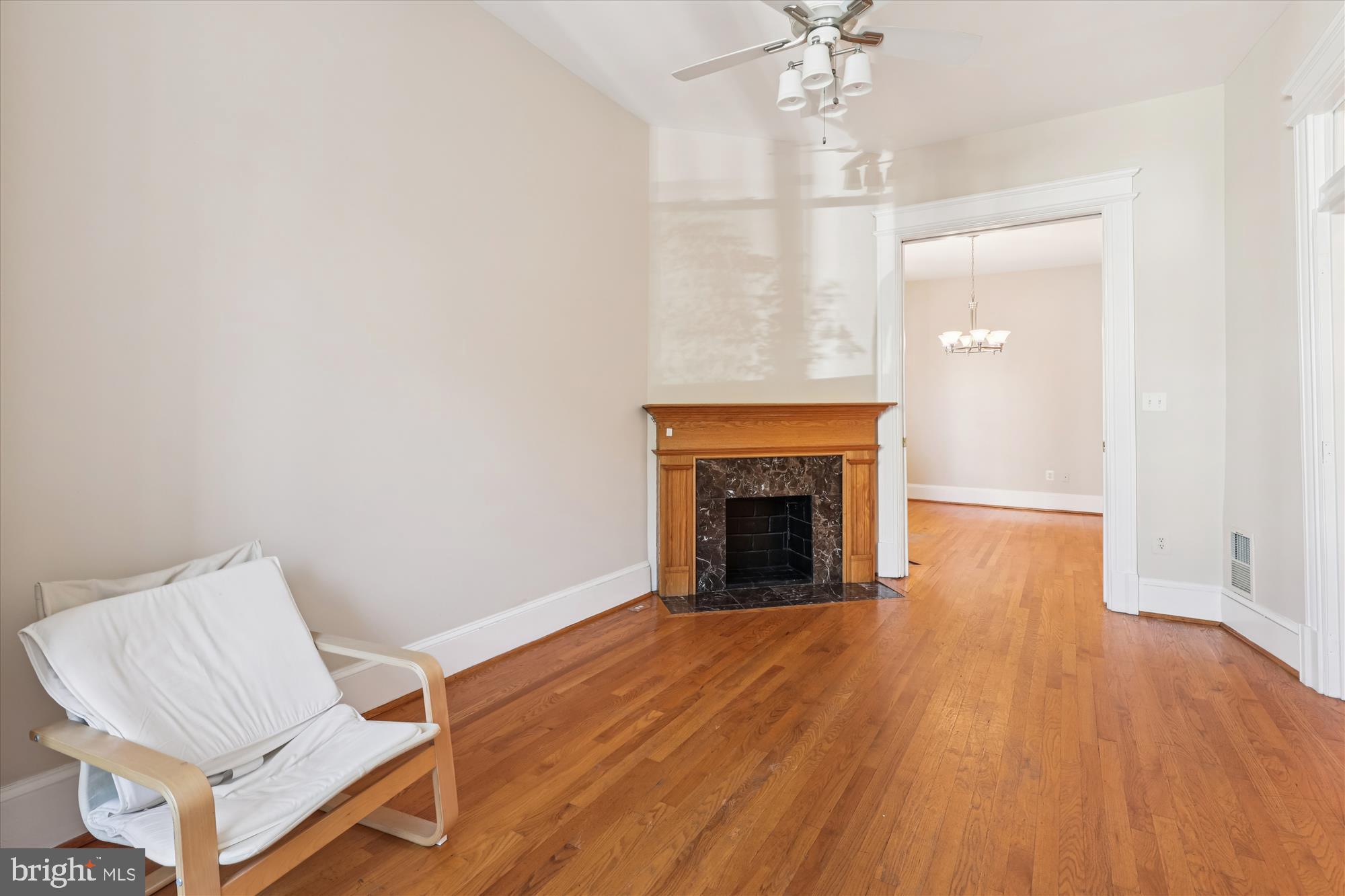 14 Seaton Place Northwest Washington, DC 20001 - Photo 12 of 46 an empty room with wooden floor a fireplace and windows