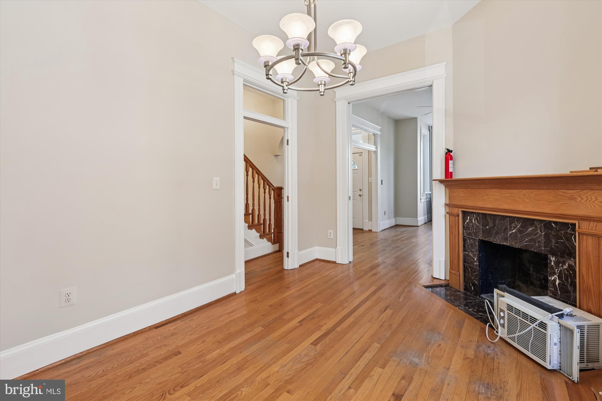 14 Seaton Place Northwest Washington, DC 20001 - Photo 14 of 46 a view of an empty room with wooden floor fireplace and a window