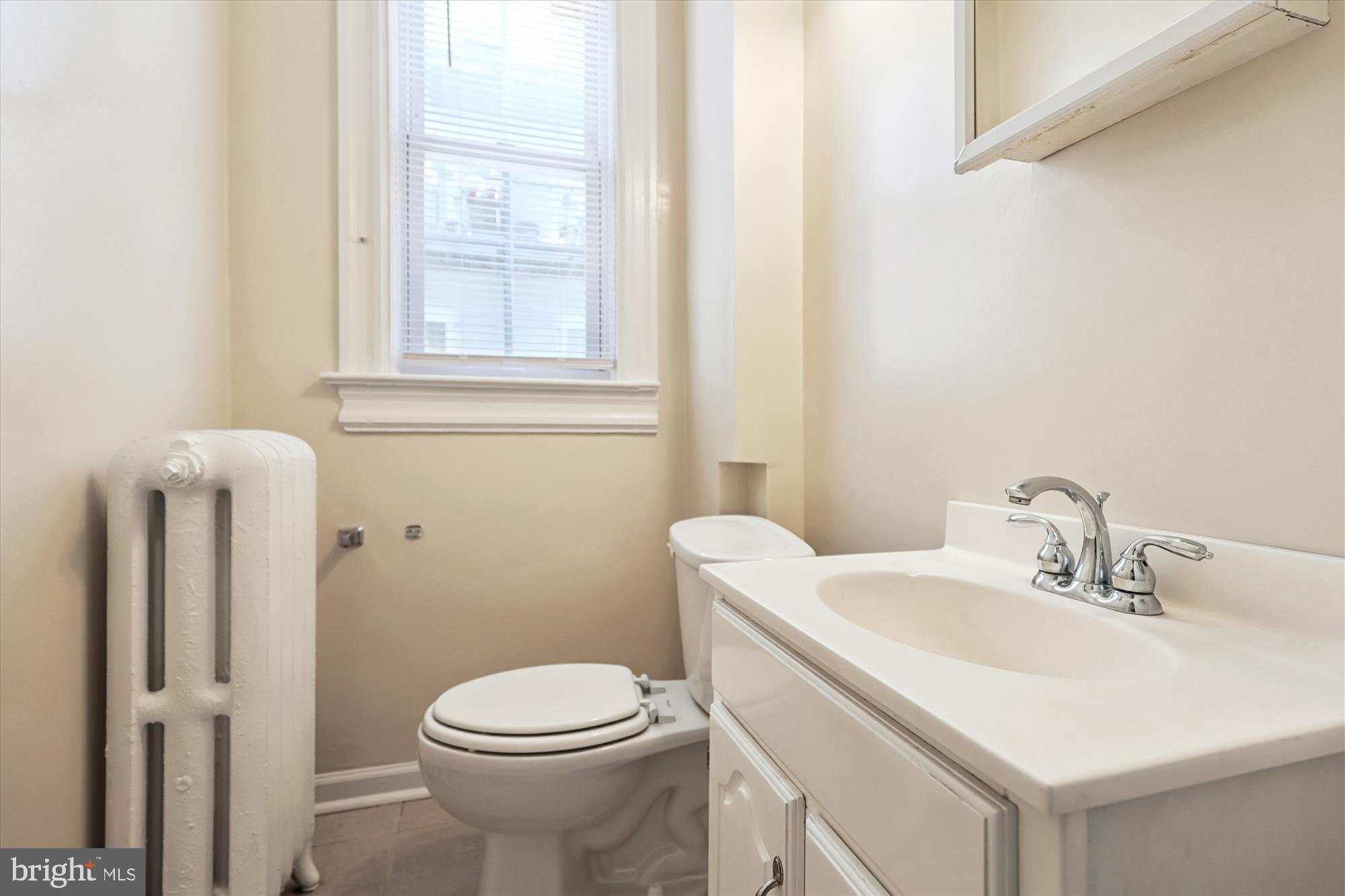14 Seaton Place Northwest Washington, DC 20001 - Photo 15 of 46 a bathroom with a sink toilet and a mirror