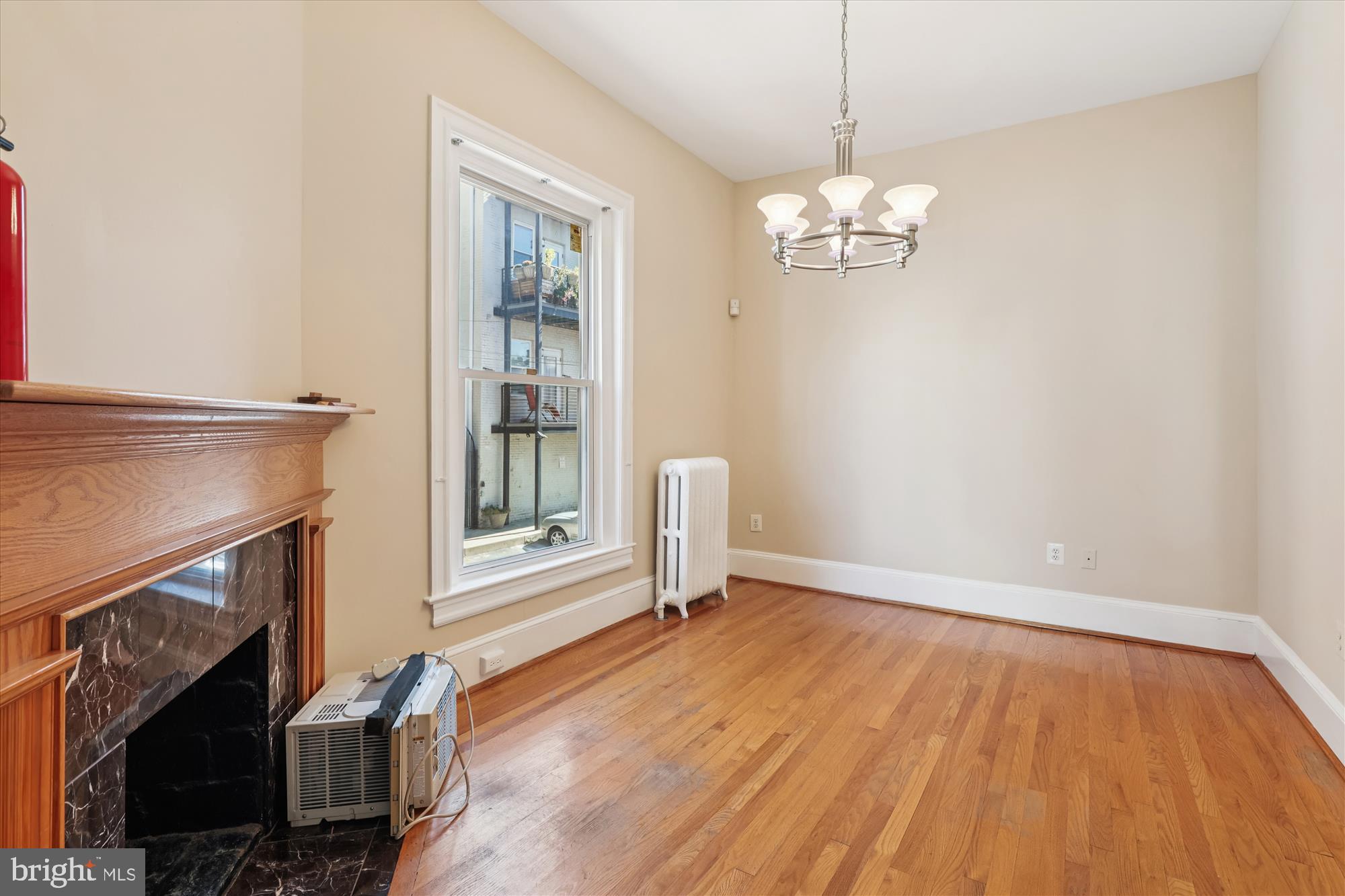 14 Seaton Place Northwest Washington, DC 20001 - Photo 16 of 46 a view of an empty room with wooden floor fireplace and a window