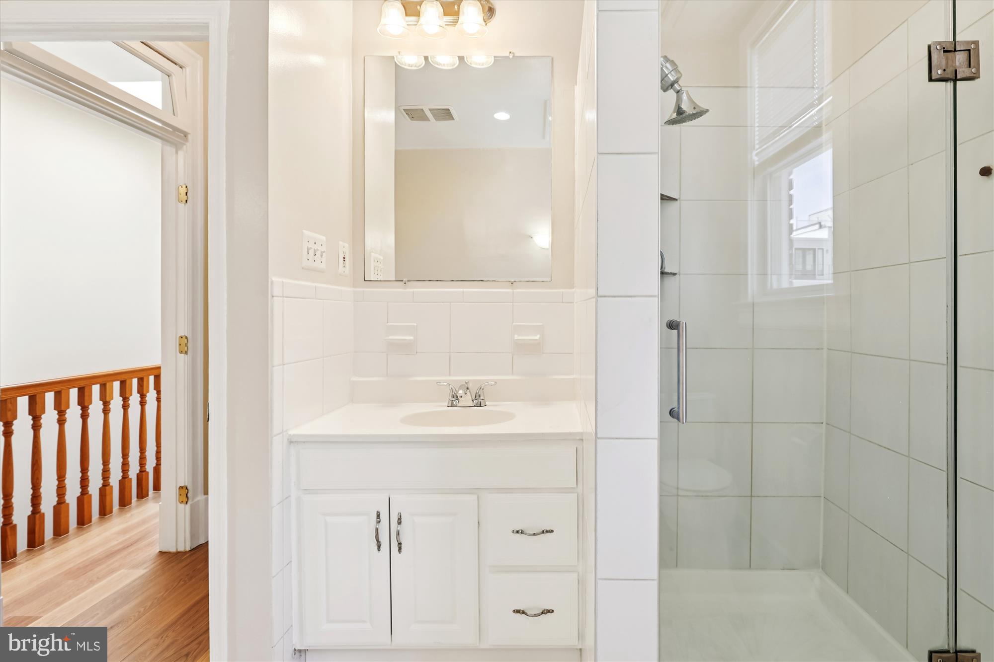 14 Seaton Place Northwest Washington, DC 20001 - Photo 29 of 46 a bathroom with a sink a shower and a mirror