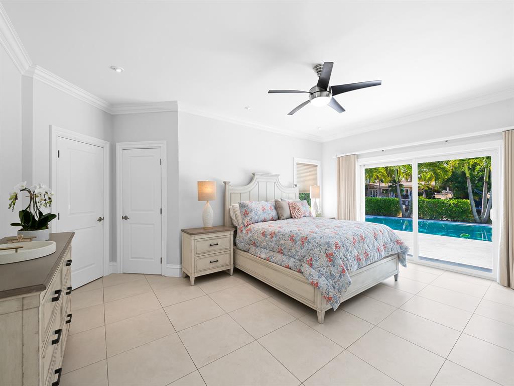 2228 Northeast 26th Street Lighthouse Point, FL 33064 - Photo 17 of 36 a bedroom with a bed and ceiling fan