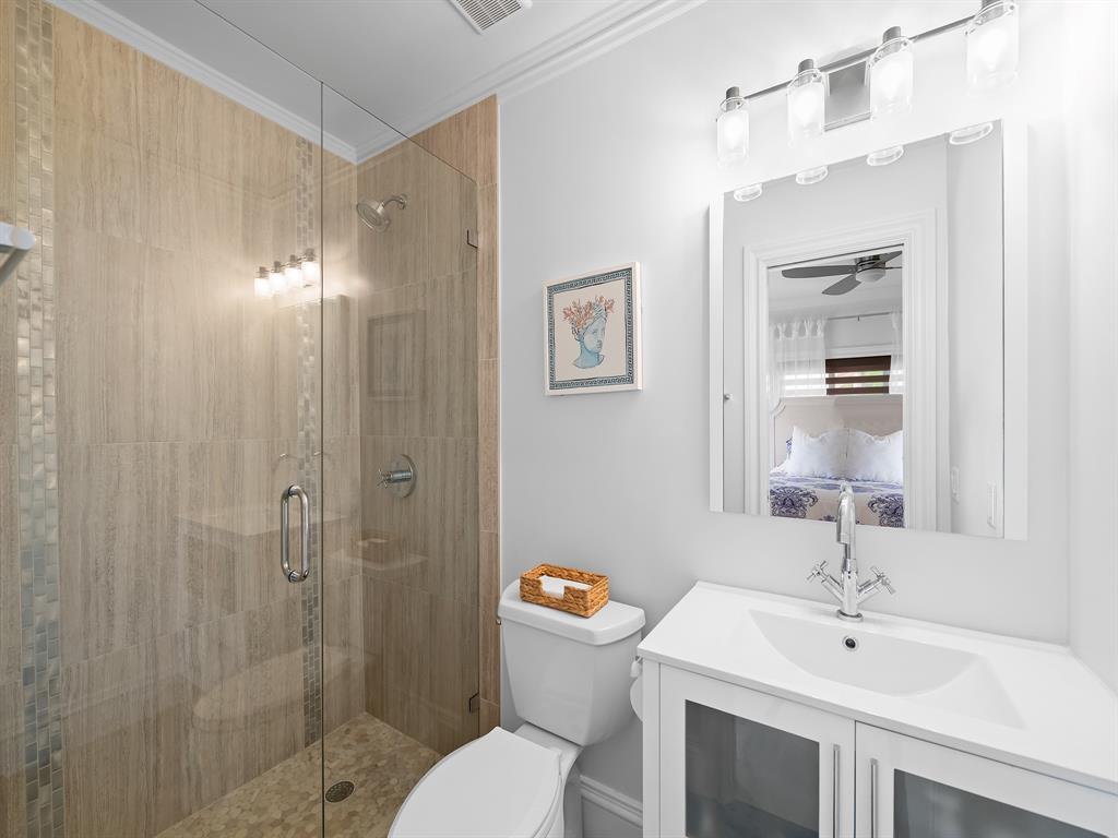 2228 Northeast 26th Street Lighthouse Point, FL 33064 - Photo 24 of 36 a bathroom with a sink mirror toilet and shower