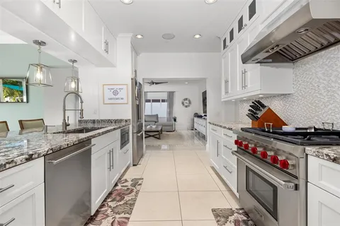 a kitchen with a stove a sink a counter top space and appliances
