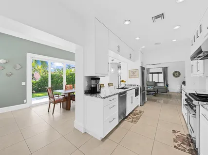 a kitchen with stainless steel appliances kitchen island granite countertop a sink and cabinets