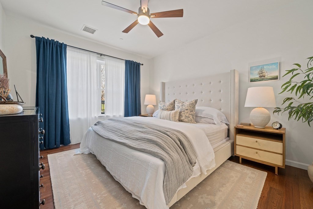 200 Revere Street, Unit 4103 Canton, MA 02021 - Photo 12 of 39 a bedroom with a bed and a chandelier