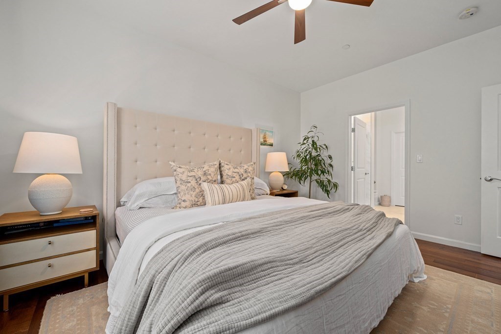 200 Revere Street, Unit 4103 Canton, MA 02021 - Photo 13 of 39 a bedroom with a bed and a chandelier