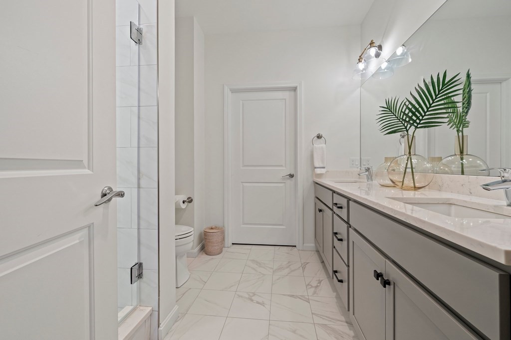 200 Revere Street, Unit 4103 Canton, MA 02021 - Photo 14 of 39 a spacious bathroom with a double vanity sink a and a mirror