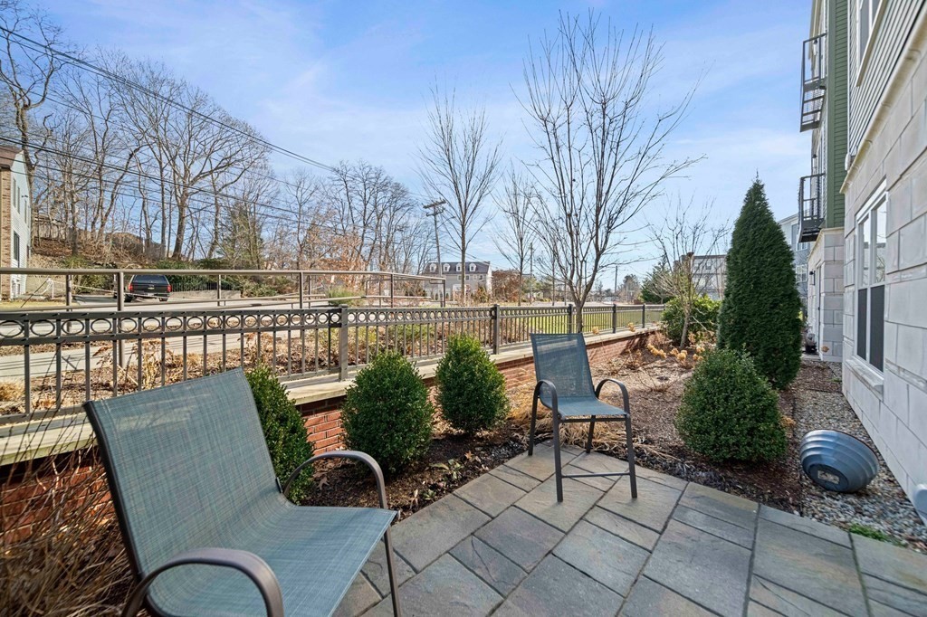 200 Revere Street, Unit 4103 Canton, MA 02021 - Photo 20 of 39 a view of a chairs and table in the patio
