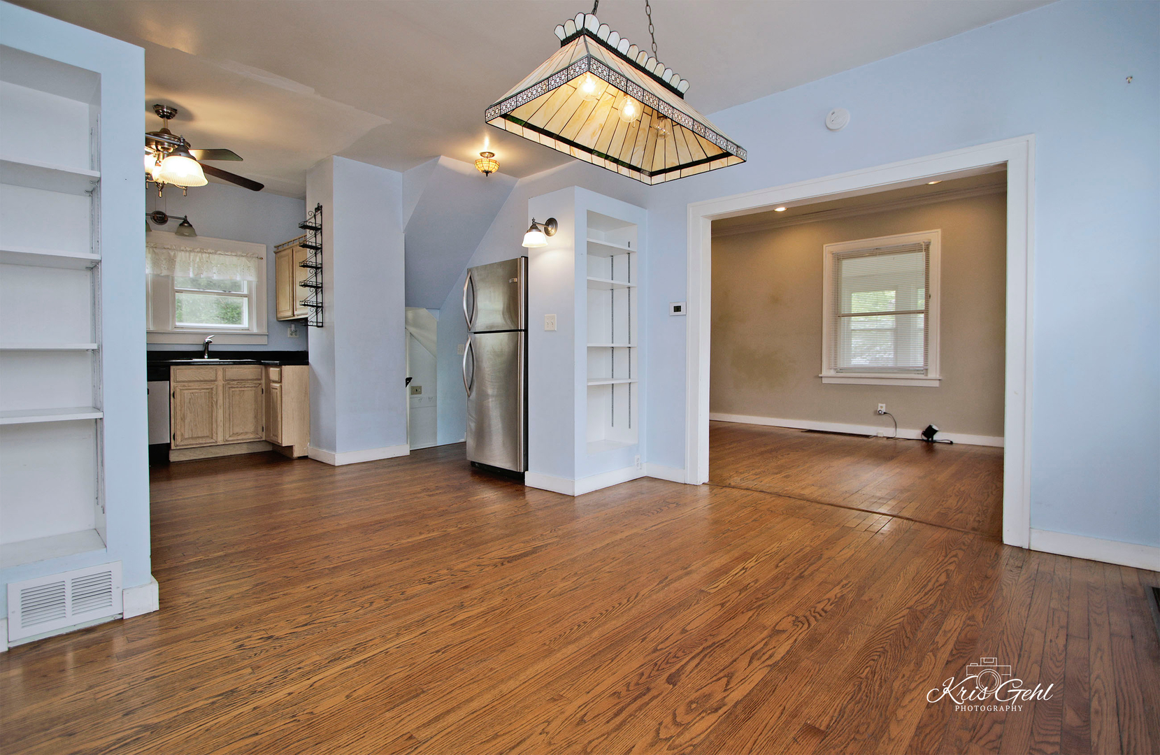 1038 Ferndale Street Gurnee, IL 60031 - Photo 6 of 24 a view of empty room with kitchen and wooden floor