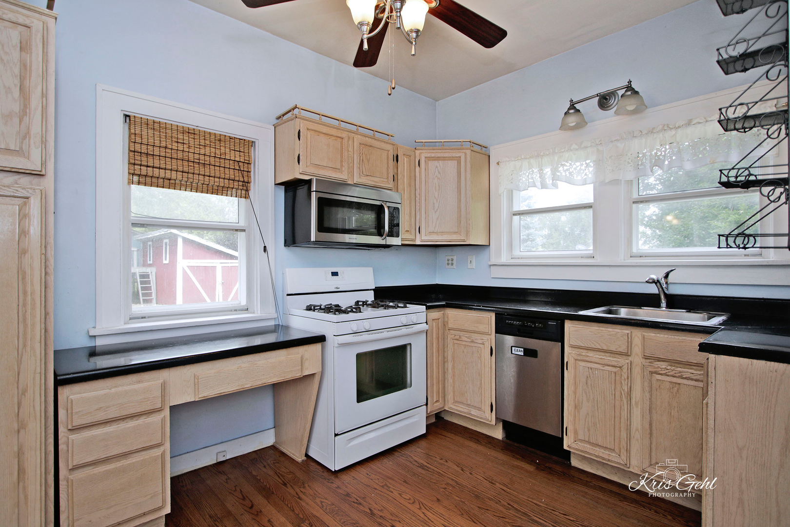 1038 Ferndale Street Gurnee, IL 60031 - Photo 8 of 24 a kitchen with granite countertop white cabinets a sink a window and appliances