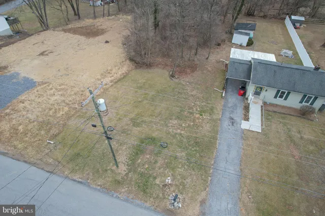 an aerial view of a house with a yard and sitting space
