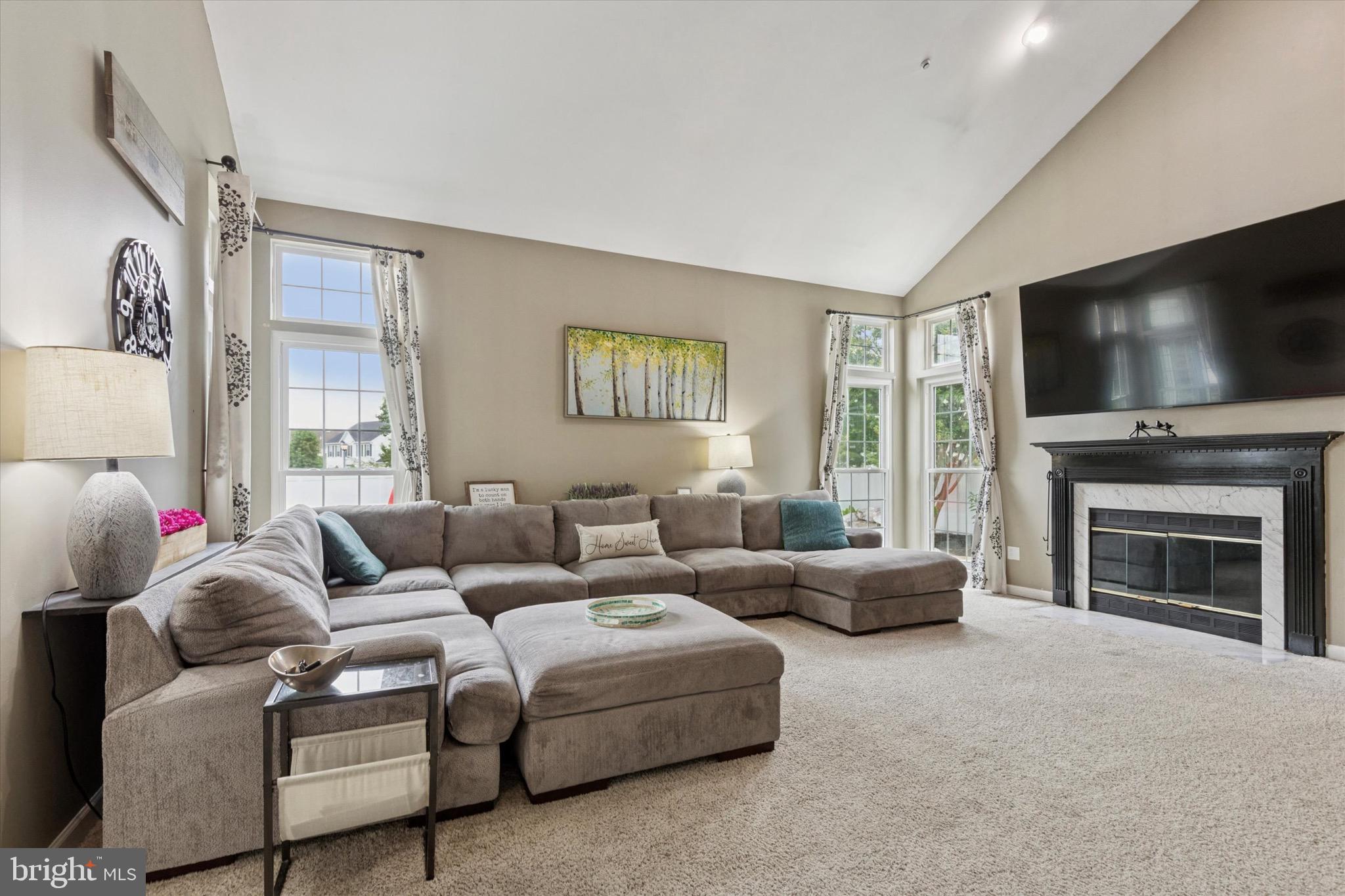 803 Sweet Cherry Street Warrington, PA 18976 - Photo 19 of 35 a living room with furniture a flat screen tv and a fireplace