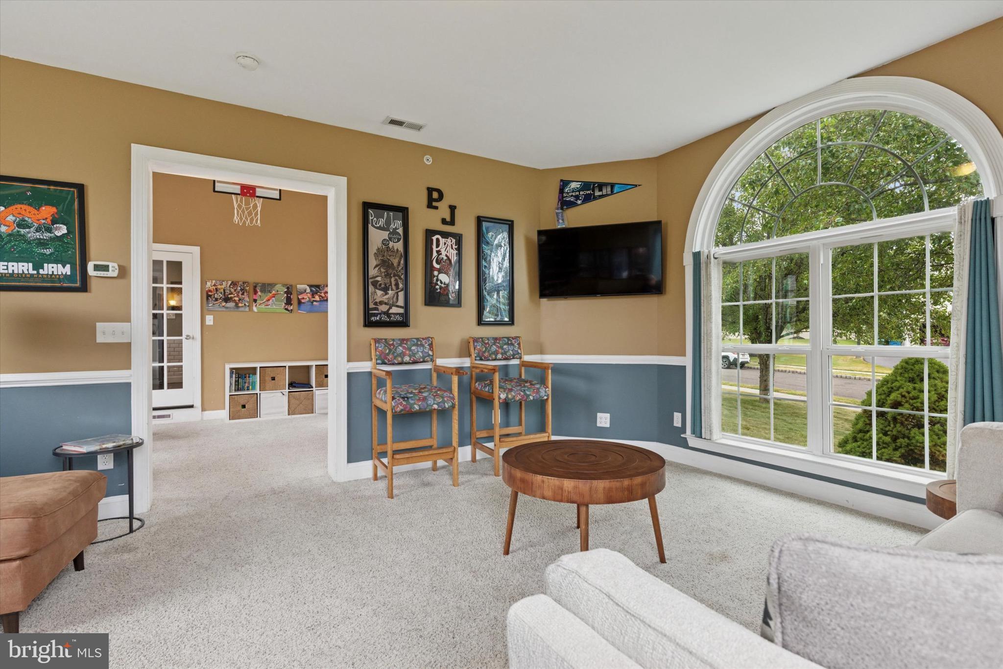 803 Sweet Cherry Street Warrington, PA 18976 - Photo 25 of 35 a living room with furniture a flat screen tv and a large window