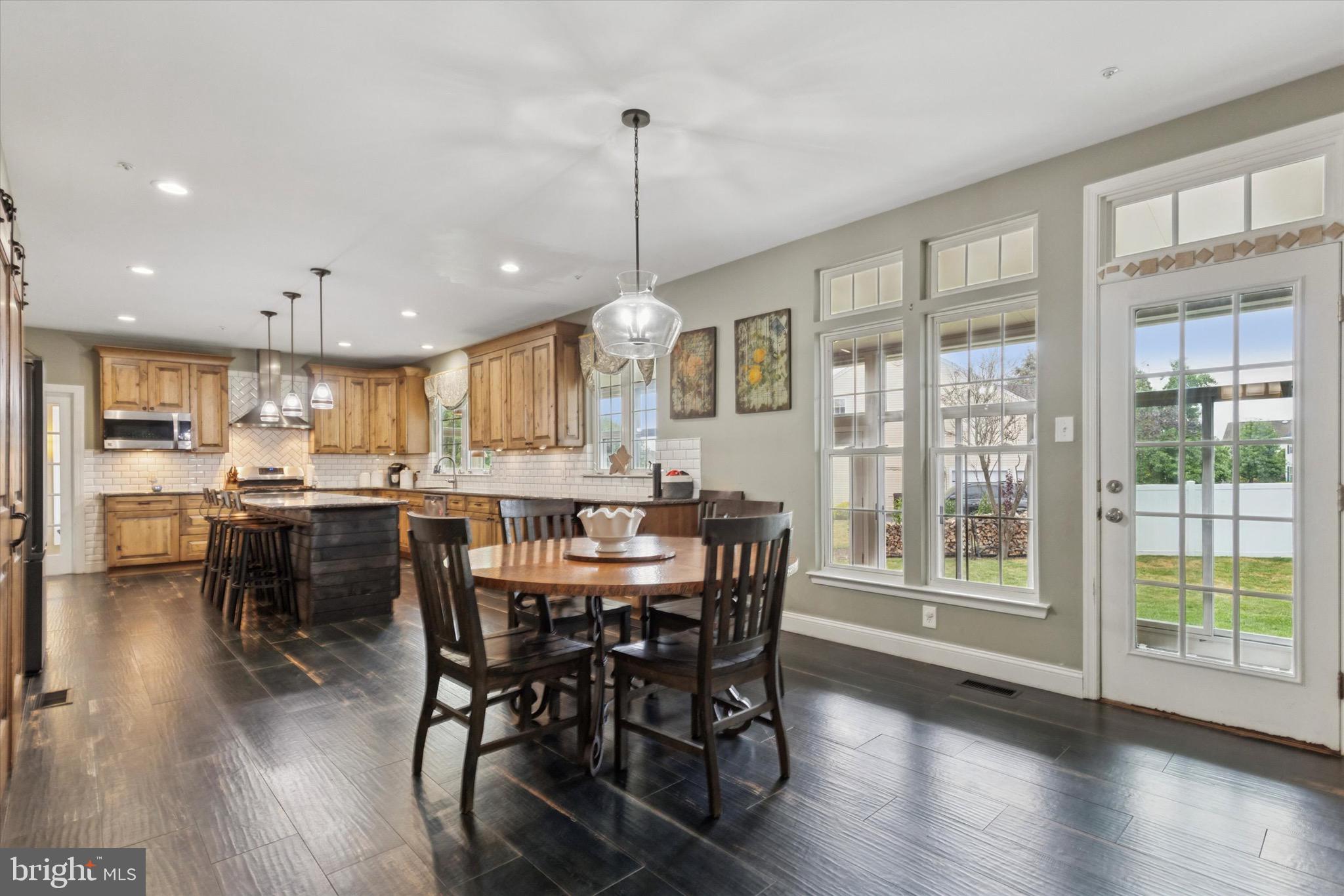 803 Sweet Cherry Street Warrington, PA 18976 - Photo 3 of 35 a view of a dining room and livingroom with furniture wooden floor a chandelier