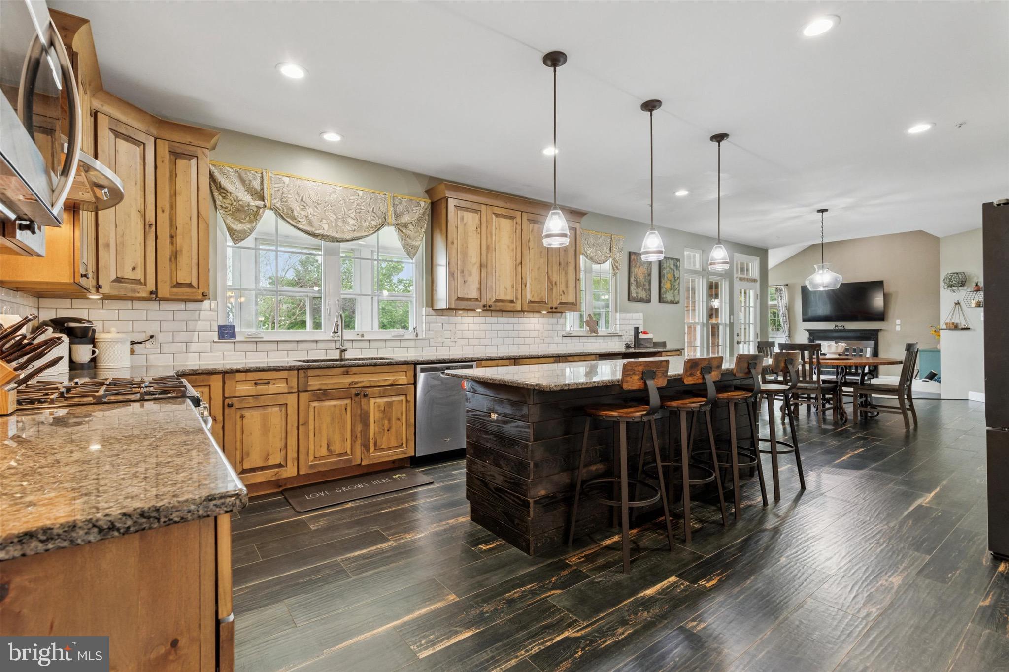 803 Sweet Cherry Street Warrington, PA 18976 - Photo 4 of 35 a kitchen with stainless steel appliances granite countertop a sink a stove and a wooden floors