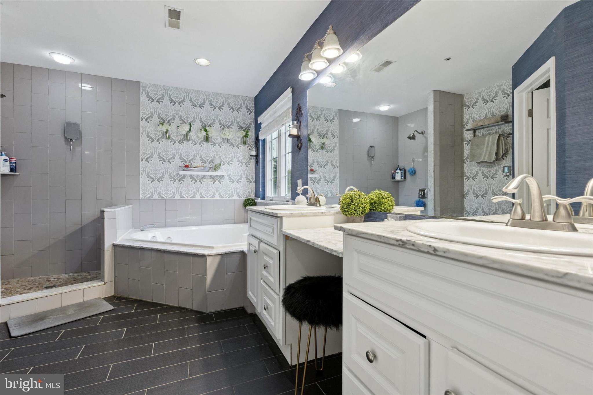 803 Sweet Cherry Street Warrington, PA 18976 - Photo 9 of 35 a spacious bathroom with a bathtub sink and mirror
