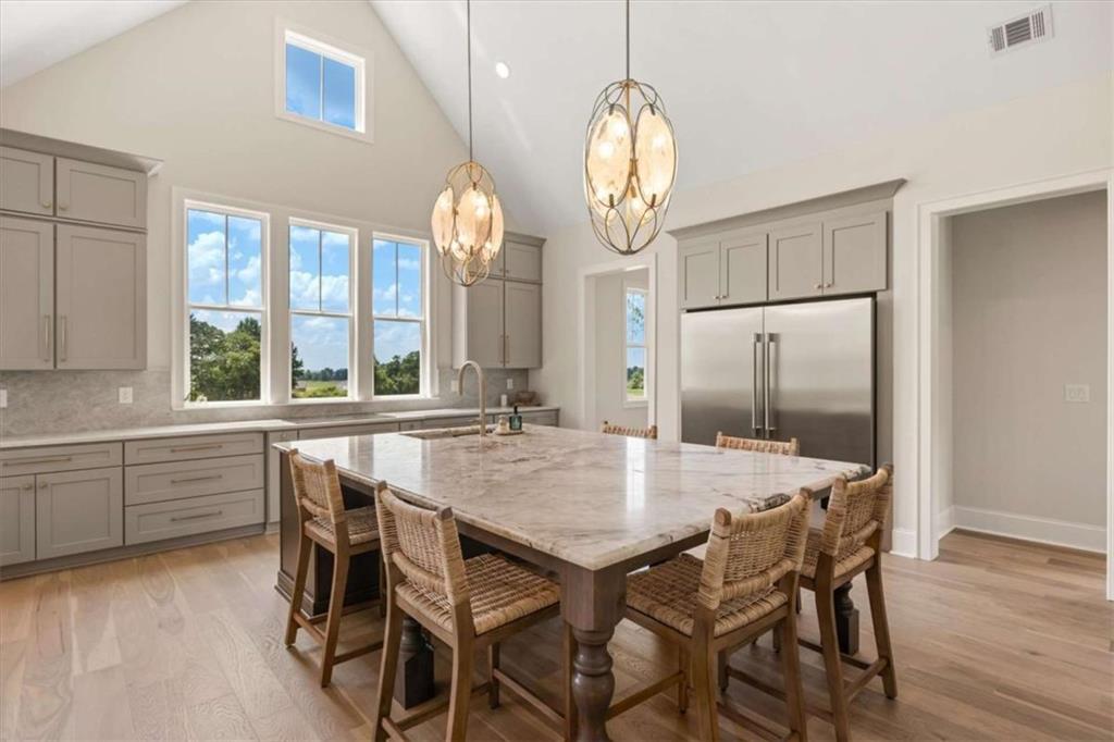 591 Welcome Road Roopville, GA 30170 - Photo 11 of 60 a view of a dining room and chandelier fan