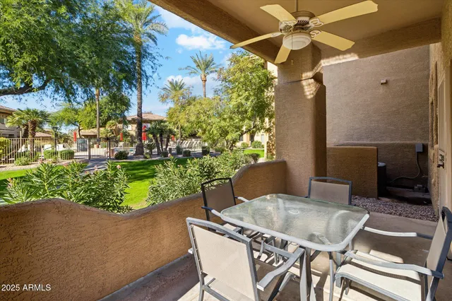 a view of a patio with table and chairs and potted plants