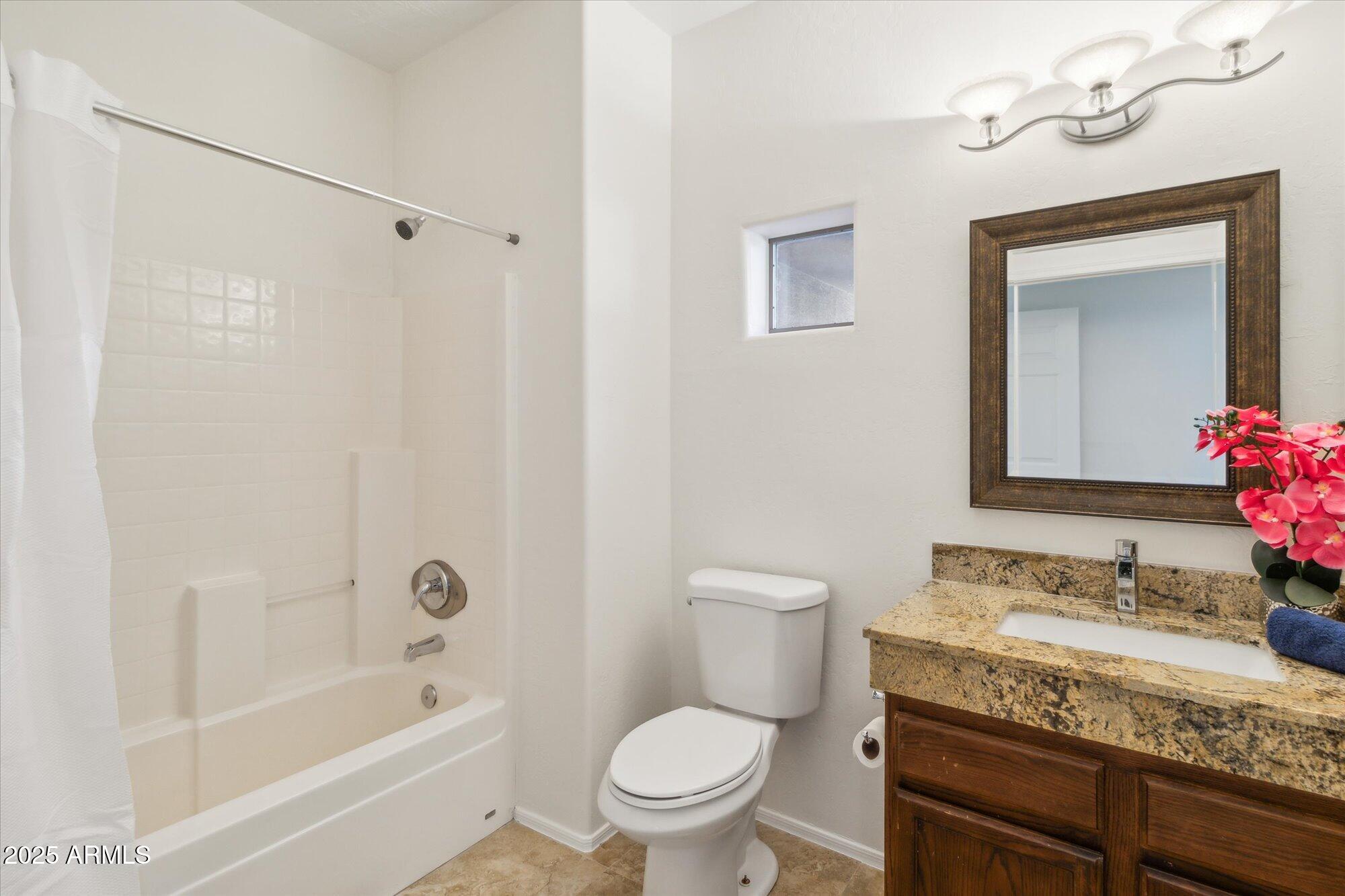9100 East Raintree Drive, Unit 130 Scottsdale, AZ 85260 - Photo 17 of 17 a bathroom with a granite countertop sink a toilet and shower
