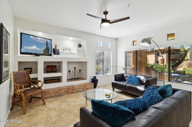 a living room with furniture a fireplace and a flat screen tv