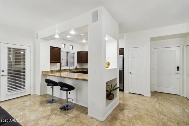 a view of a kitchen with kitchen island and a sink