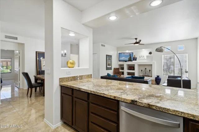 a kitchen with stainless steel appliances granite countertop a sink and a counter space